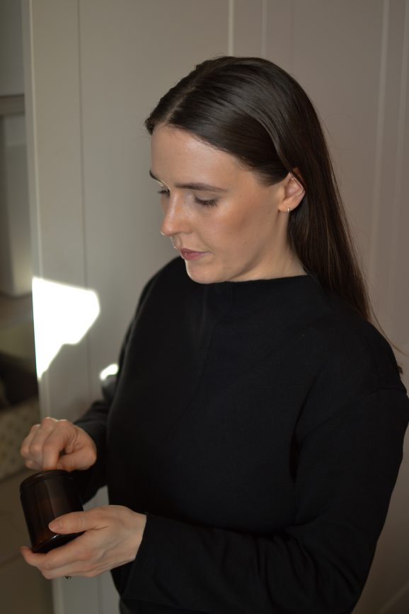 Alex scooping some of her homemade deodorant from the jar